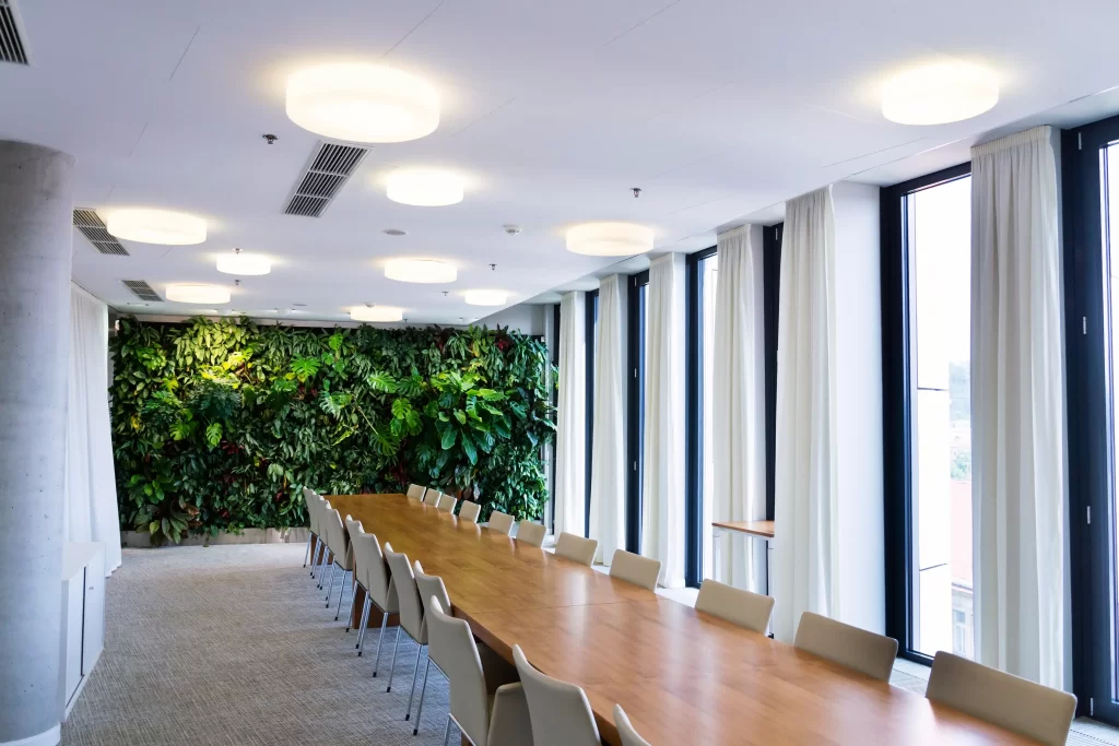 living green wall vertical garden indoors with flowers plants artificial lighting meeting modern boardroom