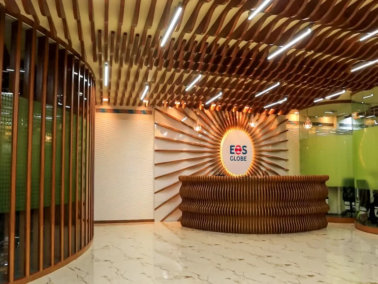 Spacious reception desk with decorative plants.